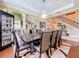Dining space with modern lighting, decorative rug, and adjoining living spaces at 1947 Marshberry Ct, Trinity, FL 34655