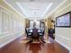Inviting dining space with tray ceiling, elegant chandelier, and hardwood flooring at 1947 Marshberry Ct, Trinity, FL 34655