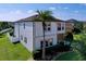 Well-maintained two-story home showcasing a covered balcony, manicured lawn, and a convenient two-car garage at 1947 Marshberry Ct, Trinity, FL 34655