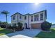 Elegant two-story home featuring a covered balcony, well-maintained landscaping, and a convenient two-car garage at 1947 Marshberry Ct, Trinity, FL 34655