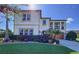 Charming two-story home showcasing a covered balcony, meticulously landscaped front yard, and a spacious two-car garage at 1947 Marshberry Ct, Trinity, FL 34655