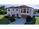 Stately two-story home with a well-manicured lawn, lush landscaping, and attached two-car garage at 1947 Marshberry Ct, Trinity, FL 34655
