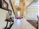 Grand foyer features high ceilings, tile floors, and an elegant staircase, creating a welcoming entrance at 1947 Marshberry Ct, Trinity, FL 34655