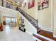 Spacious foyer featuring a grand staircase, decorative lighting, and tiled flooring at 1947 Marshberry Ct, Trinity, FL 34655