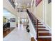 Elegant foyer showcasing a staircase, chandelier, and views into adjoining living spaces at 1947 Marshberry Ct, Trinity, FL 34655