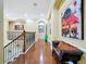 Spacious upstairs hallway with hardwood floors, art, arched doorways, and bench seating at 1947 Marshberry Ct, Trinity, FL 34655