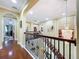 Spacious upstairs hallway with wood floors, archways, and decorative lighting fixtures at 1947 Marshberry Ct, Trinity, FL 34655