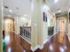 Spacious hallway featuring hardwood floors, elegant archways, and decorative molding, adding architectural charm at 1947 Marshberry Ct, Trinity, FL 34655