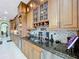 Kitchen with granite counters, stainless appliances, wine fridge, and wine rack at 1947 Marshberry Ct, Trinity, FL 34655