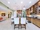 Open kitchen with island, granite counters, breakfast bar, and seamless flow to other living spaces at 1947 Marshberry Ct, Trinity, FL 34655