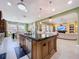Spacious kitchen with island, granite countertops, stainless appliances, and view to the dining room at 1947 Marshberry Ct, Trinity, FL 34655