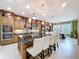 Open kitchen and dining area with large island, granite counters, and custom cabinetry at 1947 Marshberry Ct, Trinity, FL 34655