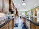 Kitchen with granite counters, mosaic tile backsplash, stainless appliances, and adjacent dining area at 1947 Marshberry Ct, Trinity, FL 34655