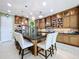 Kitchen island and countertops feature granite, and there are stainless steel appliances and custom cabinetry at 1947 Marshberry Ct, Trinity, FL 34655
