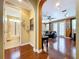 Living room with hardwood floors, ceiling fan, neutral walls, and ample natural light from the french doors at 1947 Marshberry Ct, Trinity, FL 34655