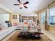 Open living room with large windows, coffered ceilings, and a ceiling fan, offering bright natural light at 1947 Marshberry Ct, Trinity, FL 34655