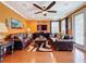 Warm living room with hardwood floors, comfortable seating, ceiling fan, and stylish decor for relaxed living at 1947 Marshberry Ct, Trinity, FL 34655