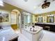 Beautiful primary bathroom featuring jacuzzi, dual vanities, and large glass shower, combining luxury and relaxation at 1947 Marshberry Ct, Trinity, FL 34655