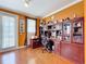 Home office with built-in shelving, hardwood floors, and ample storage for a functional workspace at 1947 Marshberry Ct, Trinity, FL 34655