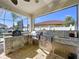 Outdoor kitchen featuring stainless steel appliances, stone accents, and convenient access to the pool area at 1947 Marshberry Ct, Trinity, FL 34655