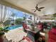 Inviting screened lanai with comfortable seating overlooking the pool and outdoor kitchen area at 1947 Marshberry Ct, Trinity, FL 34655