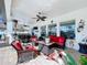 Stylish screened lanai with ceiling fans, comfortable seating, and views of the pool and outdoor kitchen at 1947 Marshberry Ct, Trinity, FL 34655