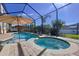 Inviting screened-in pool and spa with a surrounding brick patio and lush landscaping at 1947 Marshberry Ct, Trinity, FL 34655