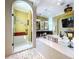 Beautiful primary bathroom featuring glass shower, jacuzzi, and modern fixtures, combining luxury and relaxation at 1947 Marshberry Ct, Trinity, FL 34655