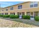 Back view of a 2 story tan home with screen patios and manicured green hedges at 213 Draw Bridge Ln, Valrico, FL 33594