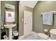 Green powder room with pedestal sink, white trim, and toilet at 213 Draw Bridge Ln, Valrico, FL 33594