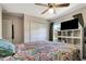 This bedroom has a large window, closet doors and a TV at 213 Draw Bridge Ln, Valrico, FL 33594
