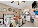 This bedroom has a ceiling fan, a TV on the wall, and a queen bed at 213 Draw Bridge Ln, Valrico, FL 33594