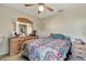 Comfortable bedroom features a ceiling fan, bureau, night table, and colorful patterned bedding at 213 Draw Bridge Ln, Valrico, FL 33594