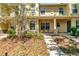 Inviting townhouse exterior featuring a covered porch and well-maintained landscaping at 213 Draw Bridge Ln, Valrico, FL 33594