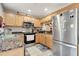 Functional kitchen boasts stainless steel appliances and maple cabinets, with granite countertops at 213 Draw Bridge Ln, Valrico, FL 33594
