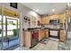 Functional kitchen with stainless steel appliances, granite counters, and access to a screened patio at 213 Draw Bridge Ln, Valrico, FL 33594