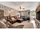 Inviting living room with a comfortable sectional sofa, ceiling fan, and a warm ambiance at 213 Draw Bridge Ln, Valrico, FL 33594
