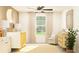 Cozy bedroom designed with a crib, a ceiling fan, carpeted floor, and a sitting chair at 22363 Nebula Way, Land O Lakes, FL 34637