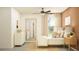 Bright bedroom featuring neutral tones, a modern ceiling fan, a large mirror, and a cozy window seat at 22363 Nebula Way, Land O Lakes, FL 34637
