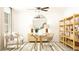 Bright home office with a glass-top desk, comfortable seating, shelving, and stylish decor for a productive environment at 22363 Nebula Way, Land O Lakes, FL 34637
