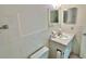 Bright bathroom showcasing a vanity sink, mirrored walls, and a toilet, exuding a clean, simple aesthetic at 2391 Sumatran Way # 37, Clearwater, FL 33763