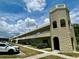 Multi-level building showcasing the architecture with stone tower and white balcony railings at 2391 Sumatran Way # 37, Clearwater, FL 33763
