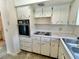 Kitchen features white cabinets and essential appliances at 2391 Sumatran Way # 37, Clearwater, FL 33763