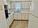 Functional kitchen with white cabinets, countertops, and standard appliances at 2391 Sumatran Way # 37, Clearwater, FL 33763