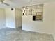 Spacious living room area featuring a ceiling fan and decorative wall shelving at 2391 Sumatran Way # 37, Clearwater, FL 33763