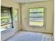 Sunlit living room with large windows, door to the back, and visible flooring project in progress at 2391 Sumatran Way # 37, Clearwater, FL 33763