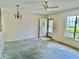 An open living space with a ceiling fan, a chandelier, and a window at 2391 Sumatran Way # 37, Clearwater, FL 33763