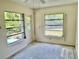 Airy room featuring windows, door to the back, and visible flooring work in progress at 2391 Sumatran Way # 37, Clearwater, FL 33763