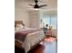 Bright bedroom featuring hardwood floors, ceiling fan and a cozy desk area perfect for studying or work at 2737 Enterprise E Rd # 192, Clearwater, FL 33759