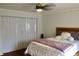 Charming bedroom with hardwood floors, updated closet and relaxing lighting fixture at 2737 Enterprise E Rd # 192, Clearwater, FL 33759